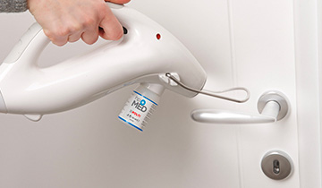 The images shows the door handle disinfection with Polti Cimex Eradifcator Plus