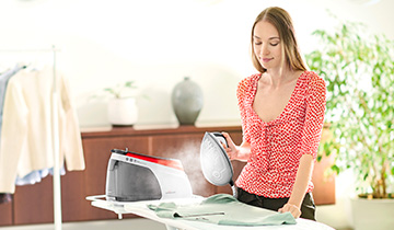 The image shows a girl who is ironing with Polti La Vaporella XM84C