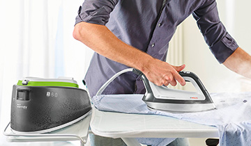 he image shows a man who is ironing a linen shirt with Polti Vaporella Instant VI30.20