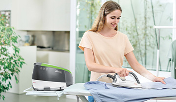 The image shows a girl ironing a shirt with Polti Vaporella Next VN18.45 