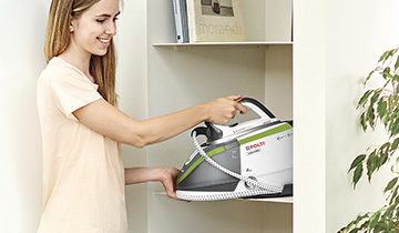 The image shows the Polti Vaporella Next VN18.45 iron seen from the side on the ironing board