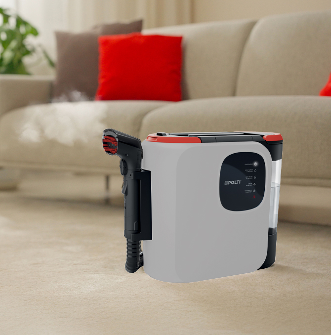 Polti StainOver spot cleaner near a sofa