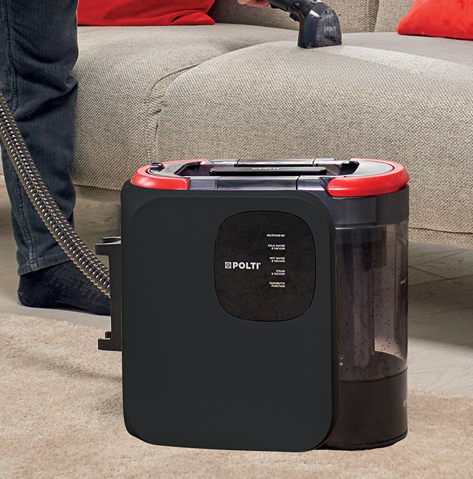 Polti StainOver spot cleaner near a sofa