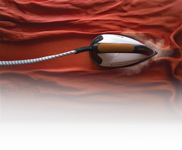 The picture shows the La Vaporella iron on a red dress